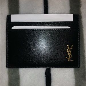 Brand new with tags YSL men’s wallet in black with gold hardware